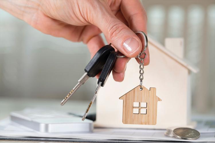 a key hanger in front of a wooden hous
